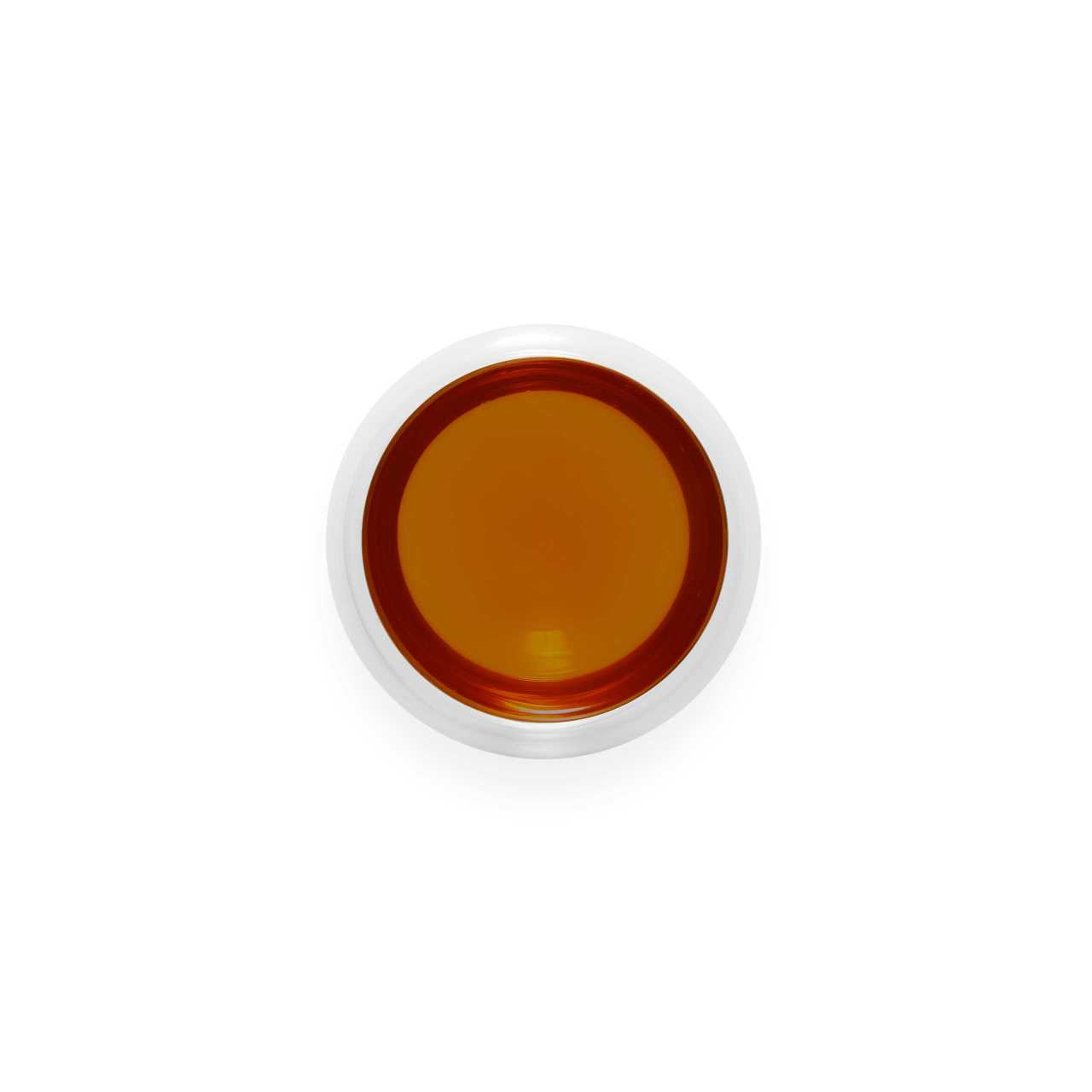 Raw Pu-Erh Cake Loose Leaf Tea infusion in a glass cup